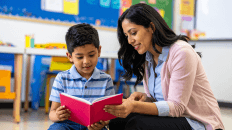 Teacher reading to a student