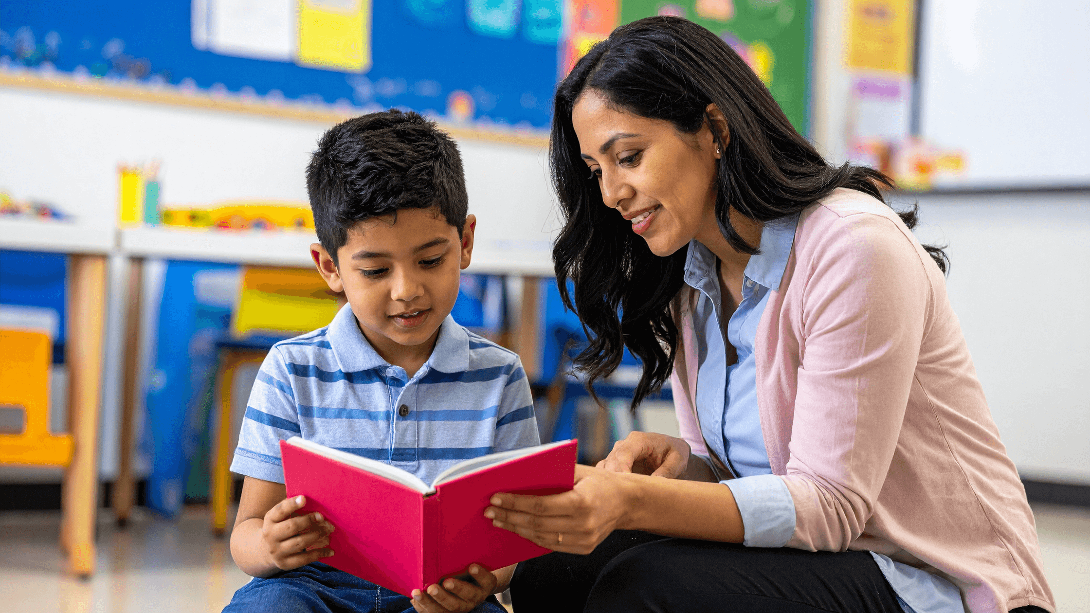 Teacher reading to a student