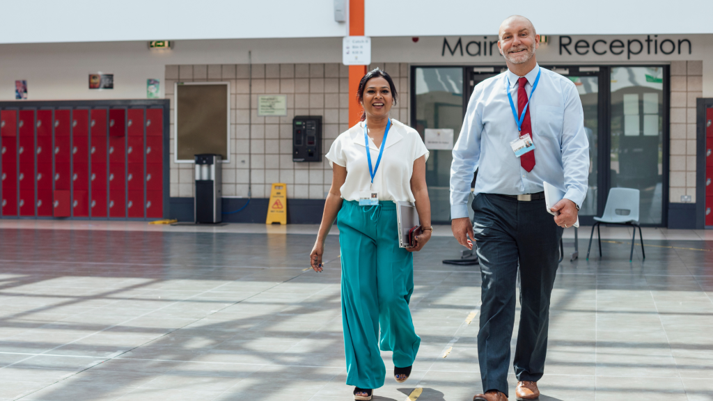 Educators walking through a school and discussing a plan