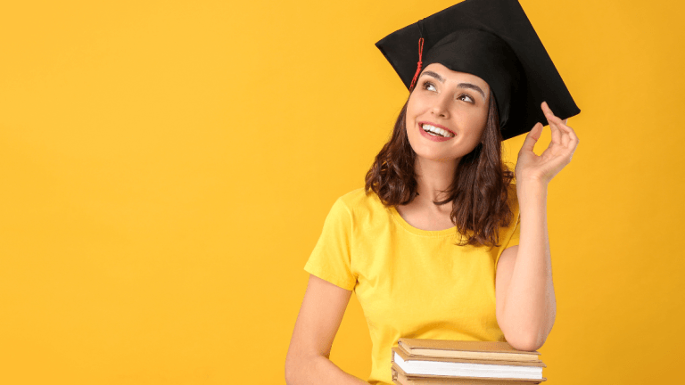 college graduate holding books