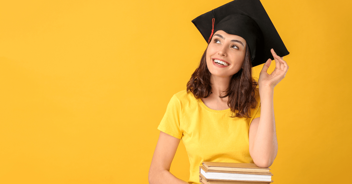 college graduate holding books