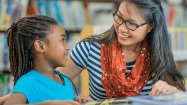 teacher working with a student