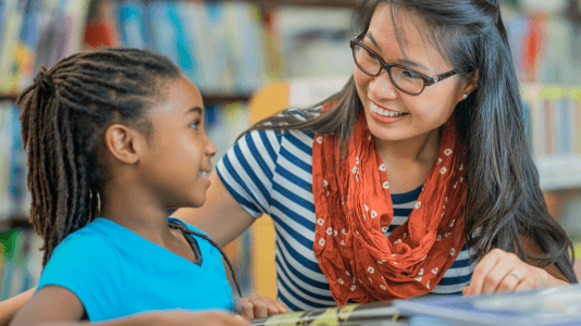 teacher working with a student